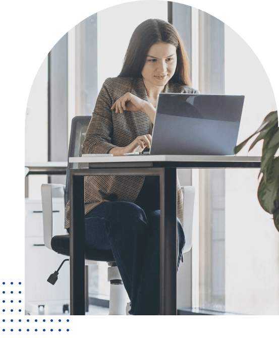A person sitting at a desk using a laptop