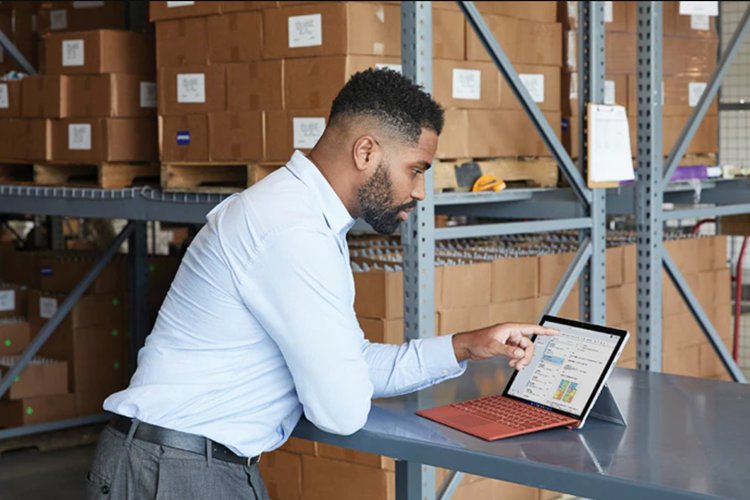 A person pointing at a laptop