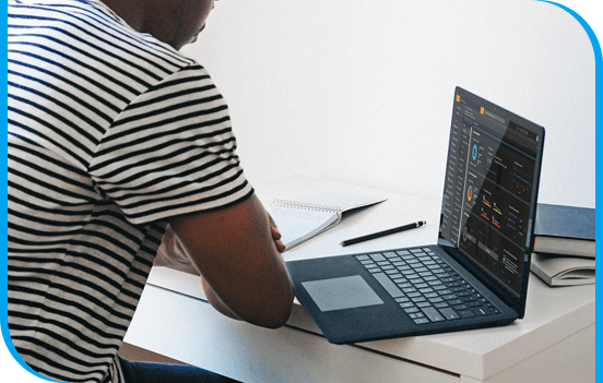 A person sitting at a desk with a laptop